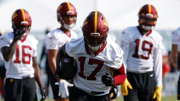 Commanders wide receiver Terry McLaurin (17) runs with the ball after making a catch during drills at practice.